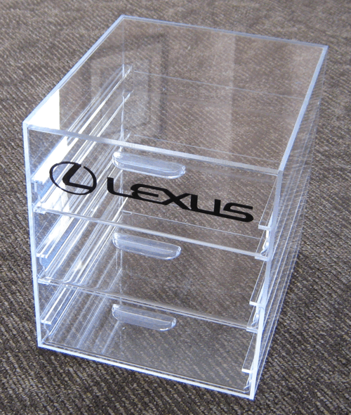 Clear acrylic desk organizer with two drawers and a Lexus logo on the front