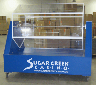 Blue Sugar Creek Casino raffle drum with clear panels in an indoor room