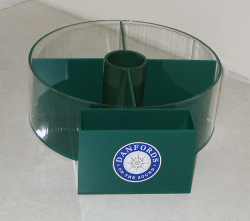 Green circular plastic display stand with a central opening and a Stanford logo on the front.