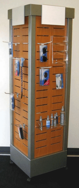 Orange slatwall retail display tower with metal base, showing hanging packaged accessories.