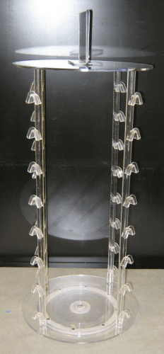 Clear cylindrical acrylic display stand with a top platform and hanging hooks on the sides