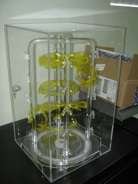 Transparent acrylic display case with a yellow spiral mechanical structure inside