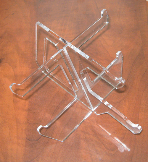 Clear acrylic stand on a wooden surface, viewed from above