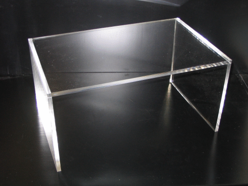 Clear acrylic table with metal frame on a black background