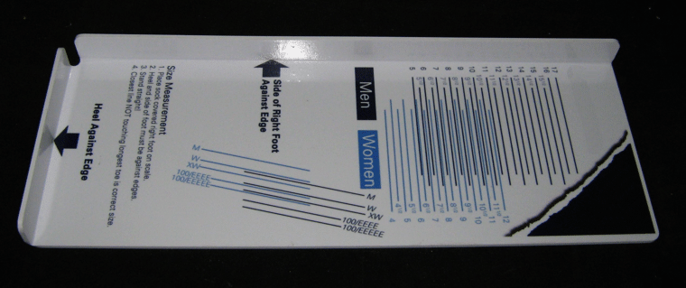 White brochure or pamphlet with blue text and graphics, lying diagonally on a dark surface.