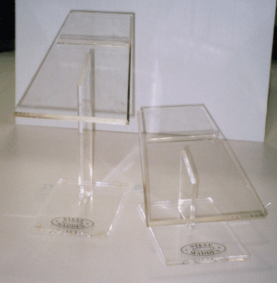 Two clear acrylic display stands with angled tops on a white surface.