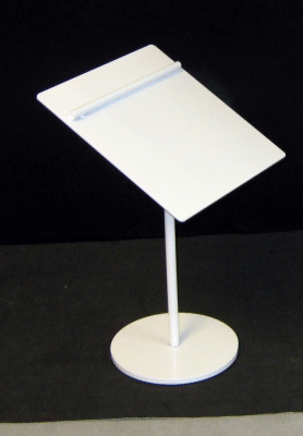 White angled signboard on a stand with a round base against a black background