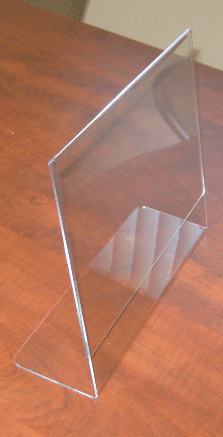 Clear acrylic brochure stand on a wooden table