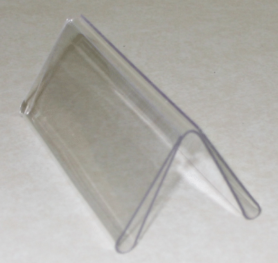 Clear plastic display stand on a light surface