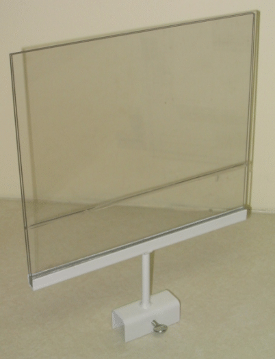 Transparent display shield on a white stand with a base, against a plain indoor wall.