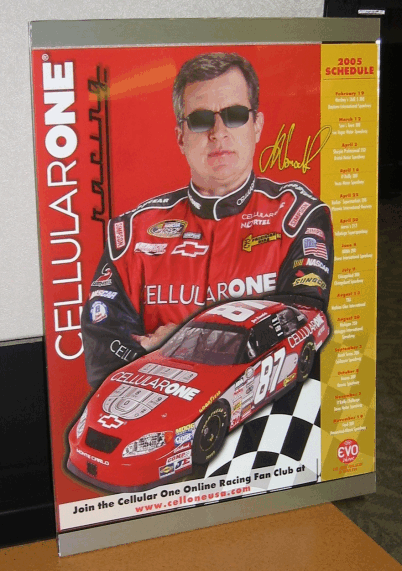 Gordon racing poster with a red race car, driver in red suit, and the name “CELLULARONE” on a yellow border