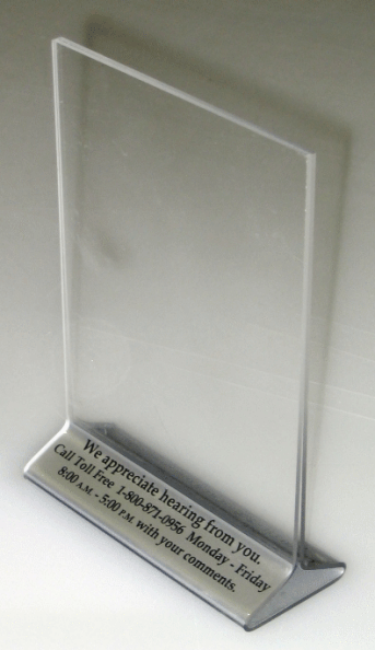Clear acrylic sign holder with a silver base and printed label on a white background
