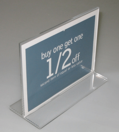 Blue tabletop sign advertising “buy one get one 1/2 off” in a clear plastic holder