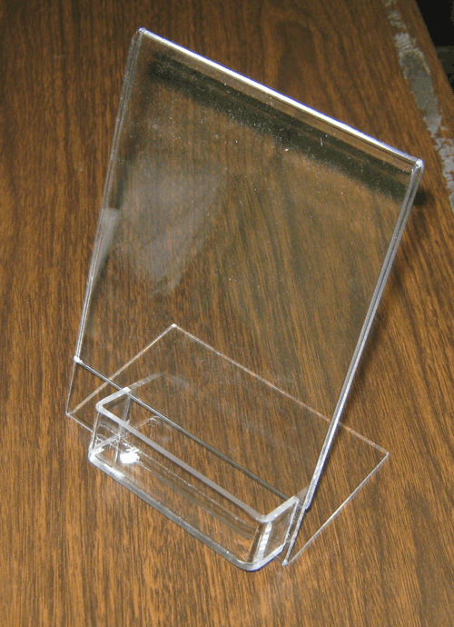 Clear acrylic brochure holder on a wooden surface
