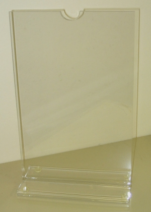 Clear plastic display stand on a beige surface, with a small top notch.