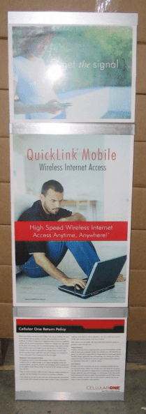 Standing banner ad for QuickLink Mobile with a man using a laptop in a blue and red layout