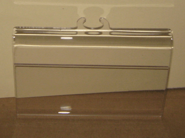 White wall-mounted radiator on a beige wall above a wooden floor