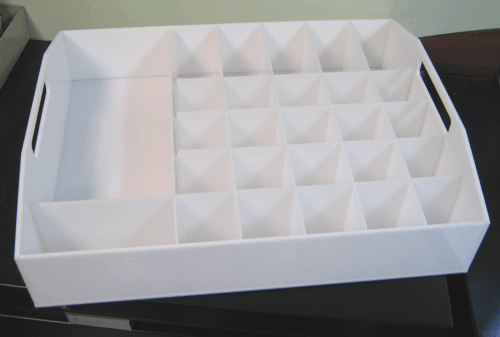 White cardboard tray with multiple small compartments, used for organizing items