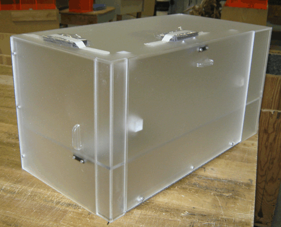 Clear plastic storage box with metal latches on a wooden table