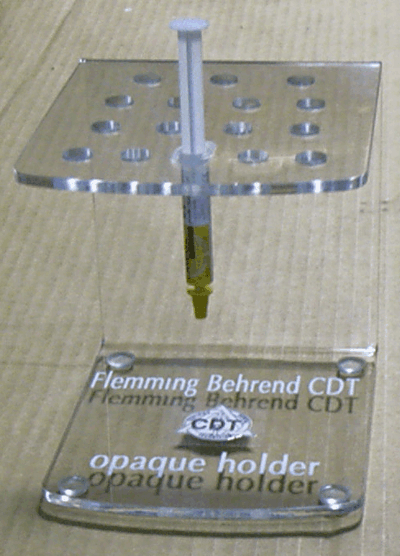 Clear acrylic dental X-ray film holder with labeled base and perforated top platform