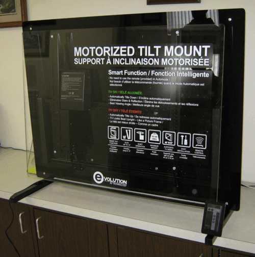 Motorized tilt mount display in a store, with black frame and product information poster.