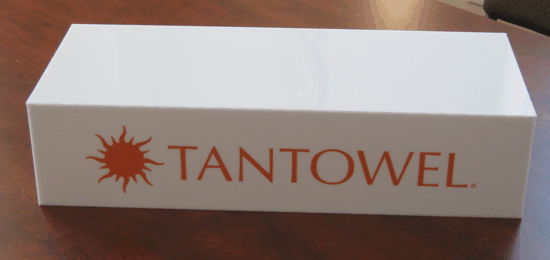 White box with orange Tantowel logo on a wooden table
