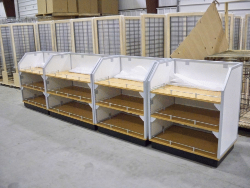 White multi-tier retail display shelves in a warehouse setting