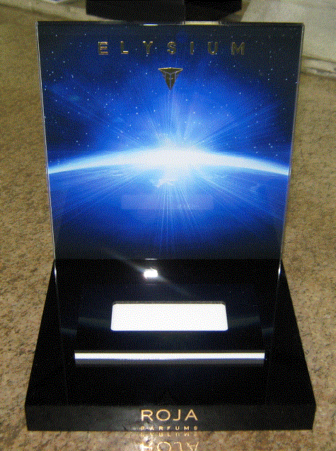 Blue ROJA perfume bottle box with a glowing horizon design and gold lettering
