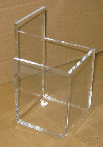 Clear acrylic desk organizer with two compartments on a brown surface