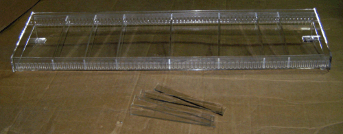 Wire rack and several wooden chopsticks on a brown surface.