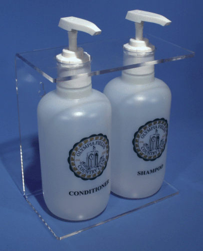 Two white pump bottles in a clear holder, labeled conditioner and shampoo.