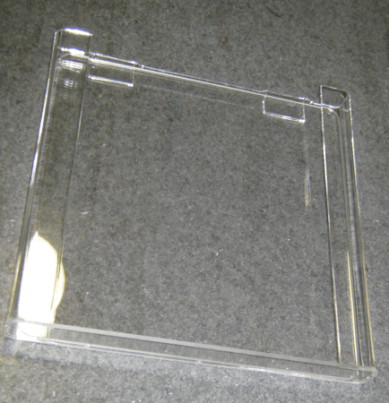 Clear plastic display cover on a gray fabric surface