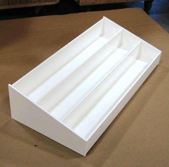 White cardboard display tray with three long compartments on a wooden surface