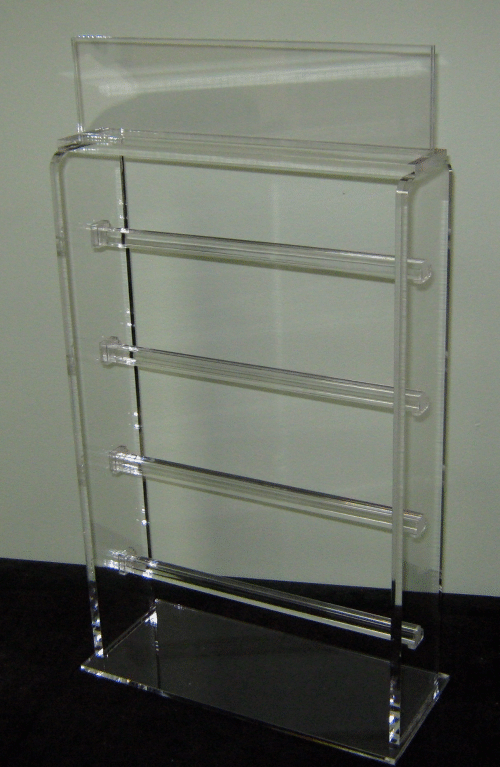 Clear acrylic wall-mounted display shelf with four horizontal tiers on a white background