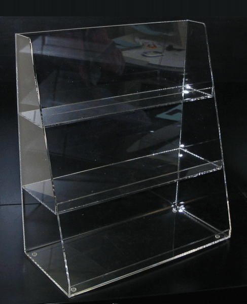 Clear acrylic display shelf with four tiers on a dark background