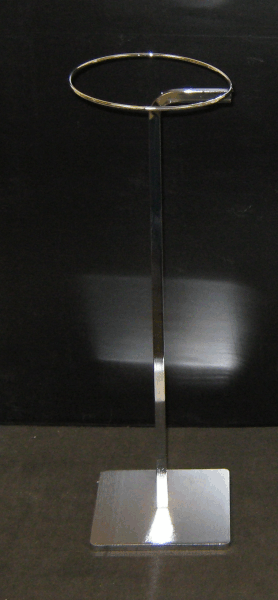 Tall metal display stand with a circular ring top and square base on a dark background