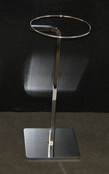 Stainless steel display stand with a rectangular base and oval ring top on a dark background