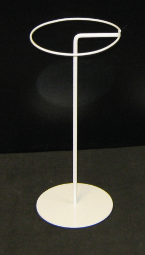 White metal standing ring with a vertical pole on a round base against a dark background