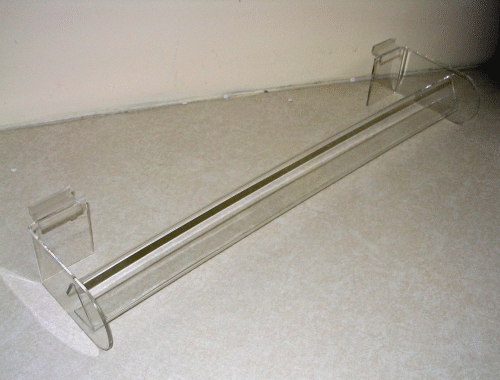 Clear acrylic paper towel holder with chrome rods on a beige surface