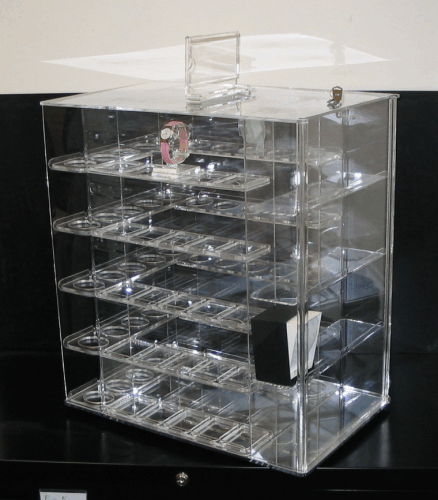 Clear acrylic multi-drawer storage box with many small compartments on a dark surface