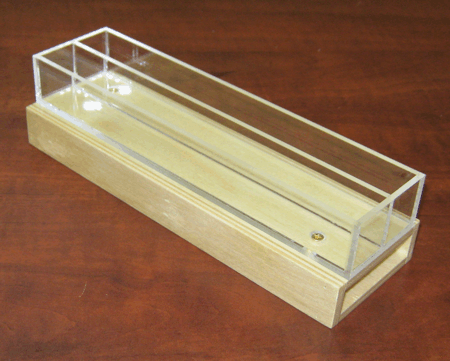 Clear acrylic rectangular display case on a wooden base