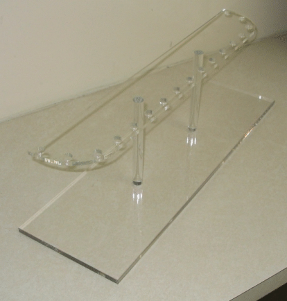 Clear acrylic display stand on a white surface
