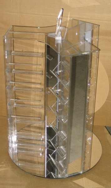 Clear plastic rotating makeup organizer with compartments and a central mirrored panel