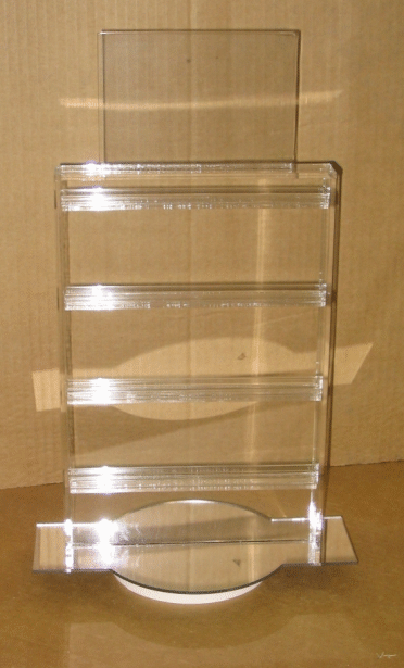 Clear acrylic brochure holder with four pockets on a wooden surface.