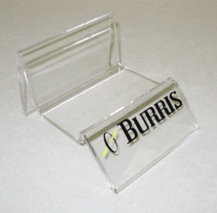Clear acrylic business card holder with the BURRIS logo on a light background