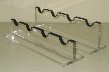 Clear acrylic display riser with three tiered shelves and black wavy rails on top.