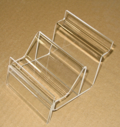 Clear acrylic wire rack holder on a brown surface