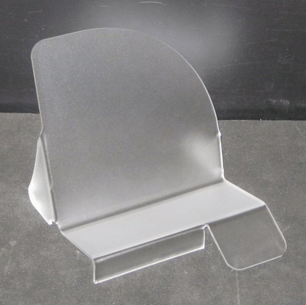 Clear acrylic display stand with a slanted back and front lip on a gray surface