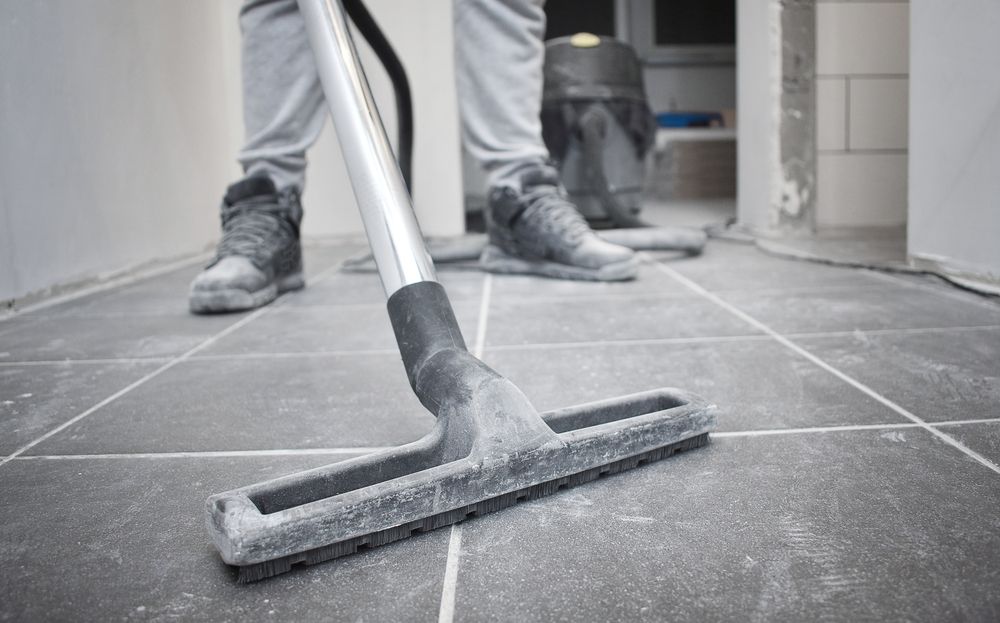 Person Vacuuming a Dusty Tiled Floor — Crystal Clear In Walcha, NSW