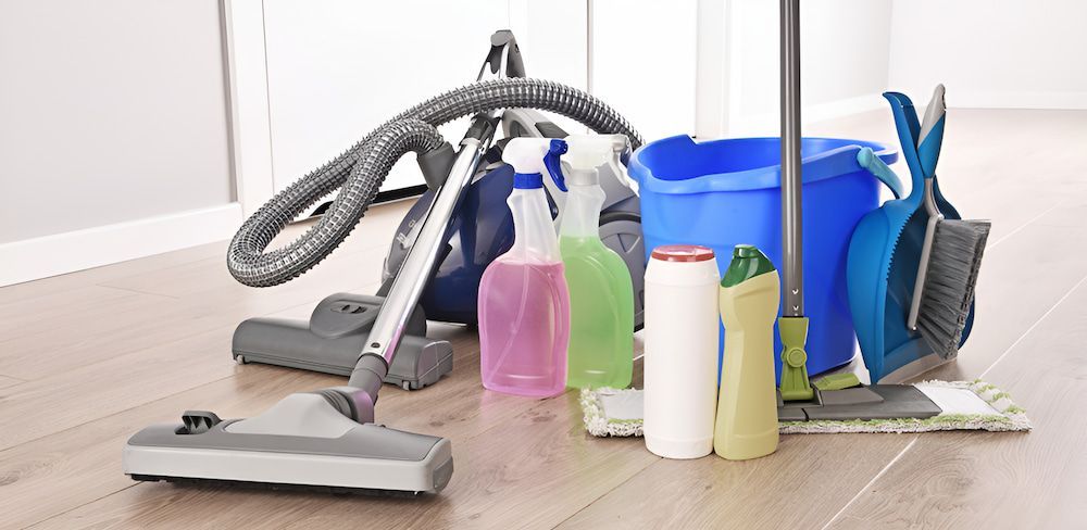 A Vacuum Cleaner, Mop, Bucket And Cleaning Supplies Are On The Floor — Crystal Clear In Armidale, NSW